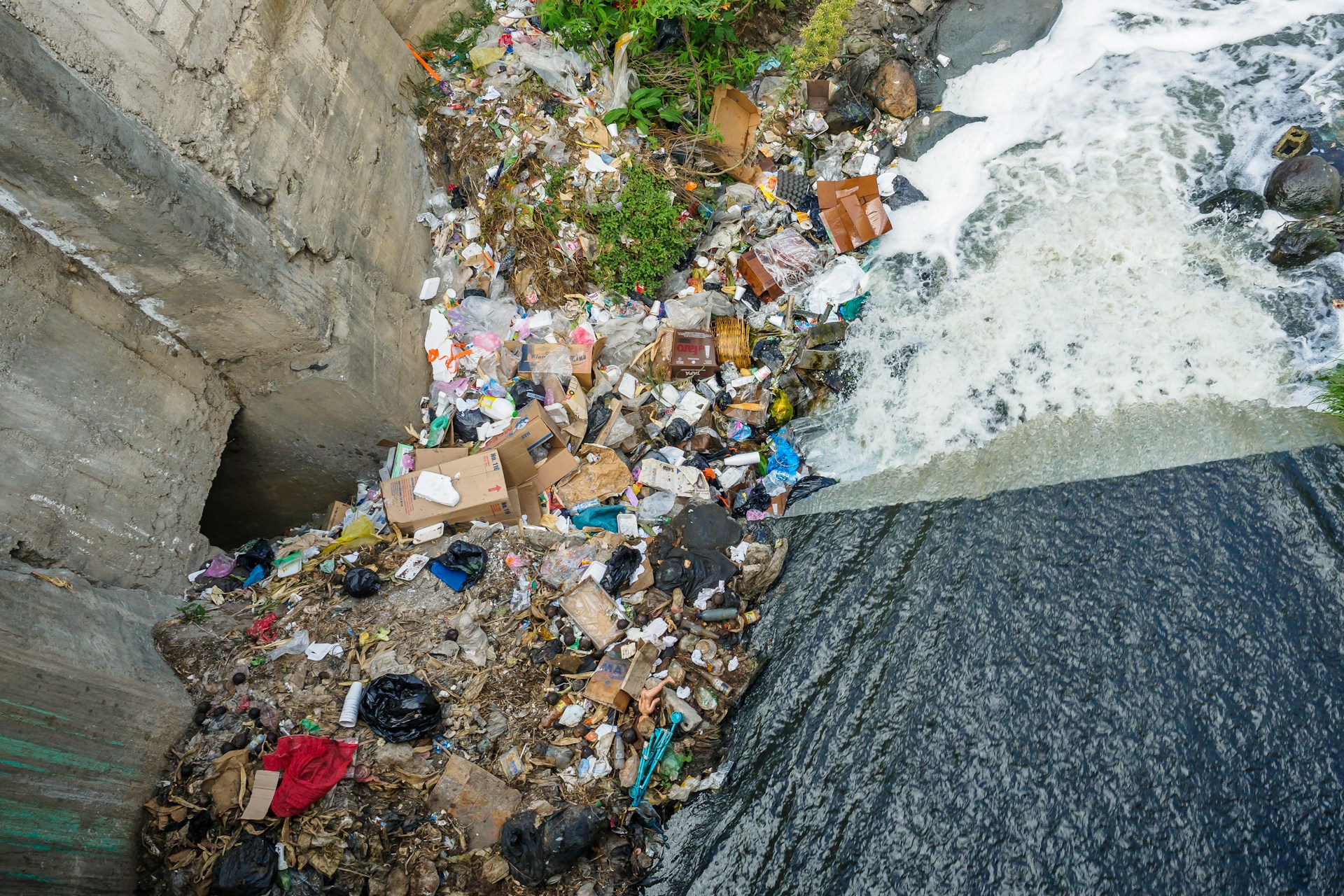 Plastic pollution at the bottom of a waterfall