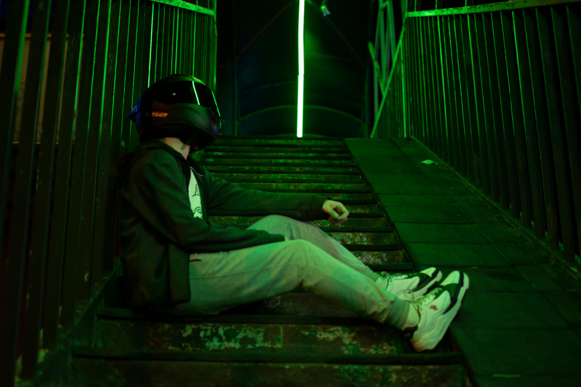 person sitting with virtual reality headset in green light