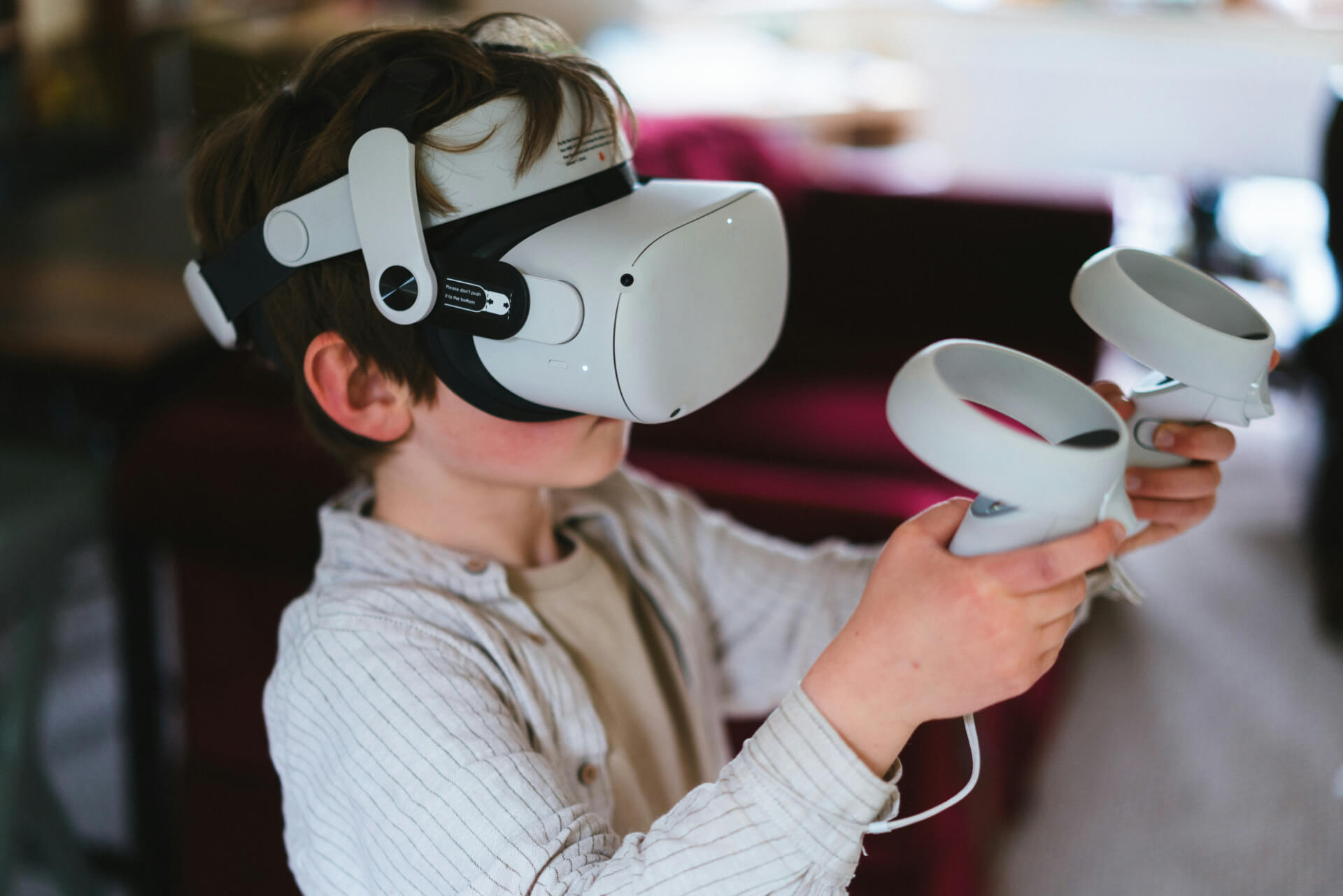 child with virtual reality headset and controllers