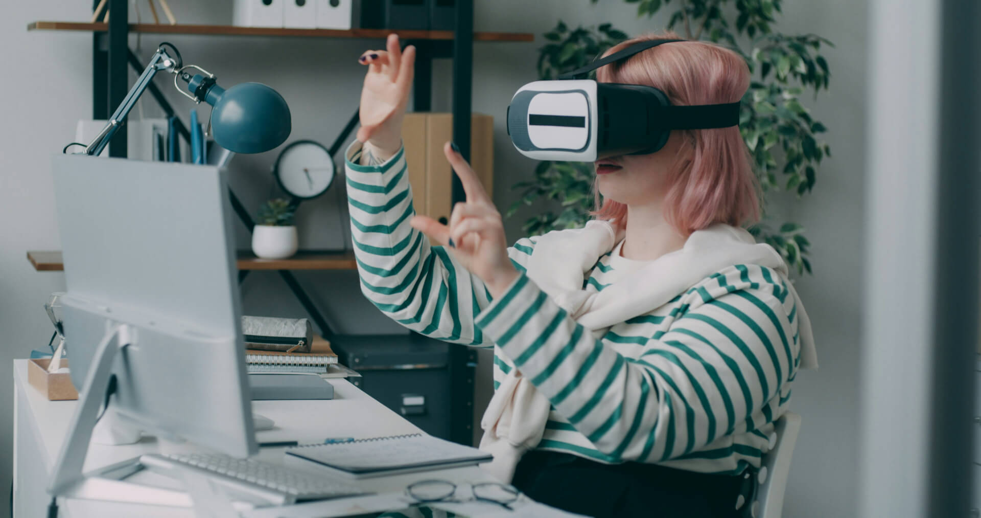 person sitting at a desk with a virtual reality headset on