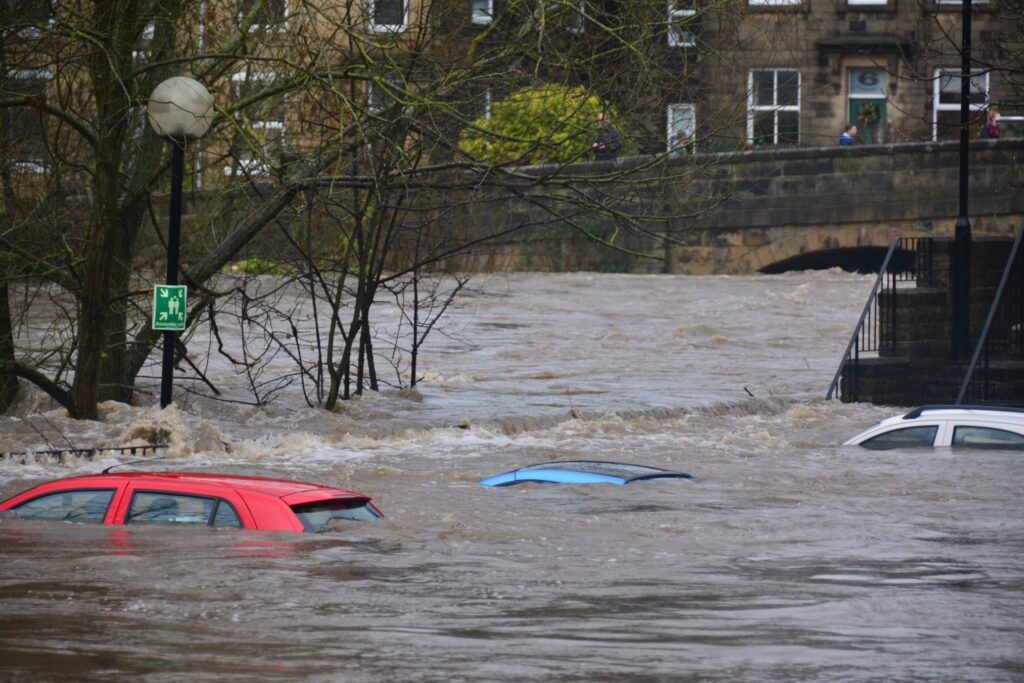 Flood waters almost reaching the tops of cars