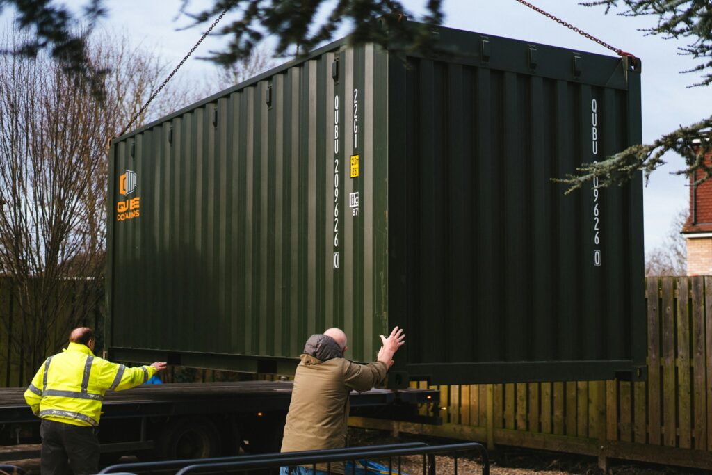 Men moving a shipping container