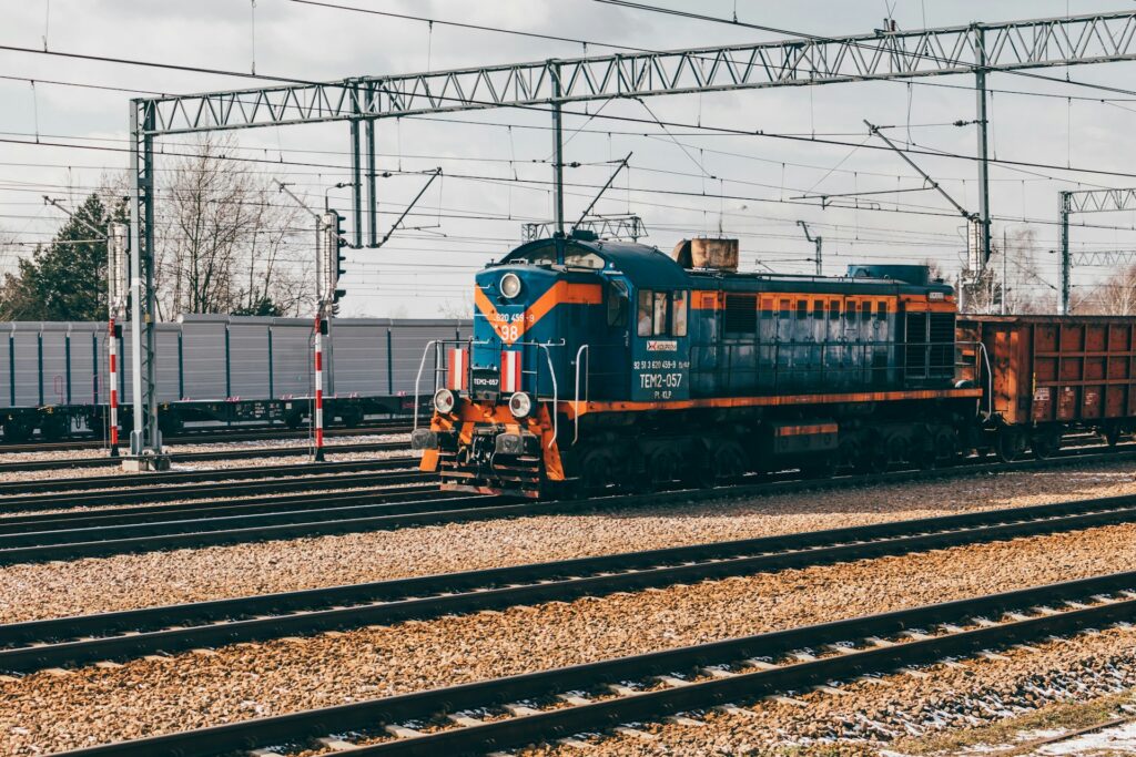 Blue freight train surrounded by electric infrastructure