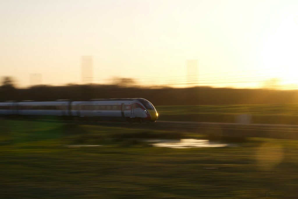 Train blurring past field