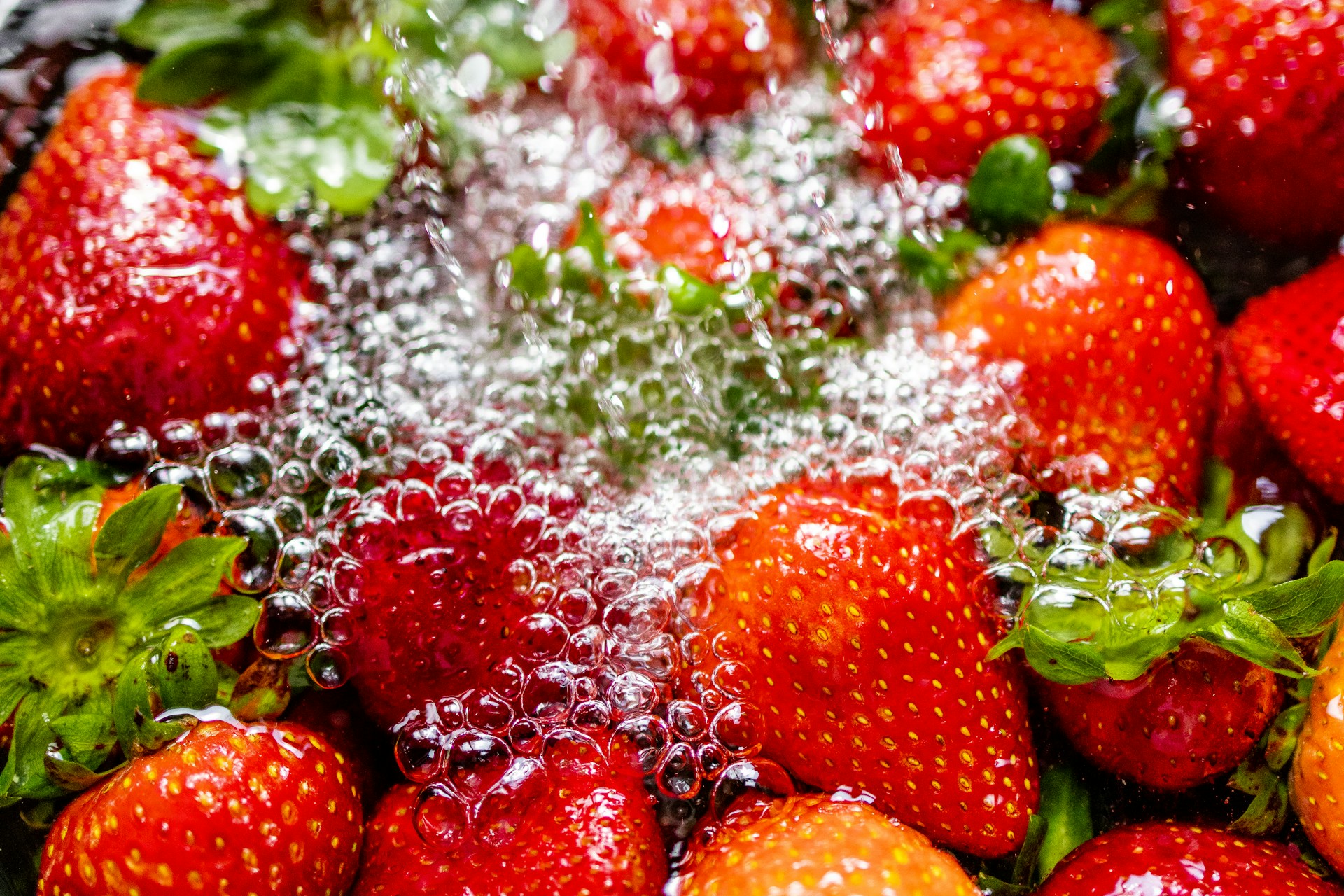 Strawberries soaking in water