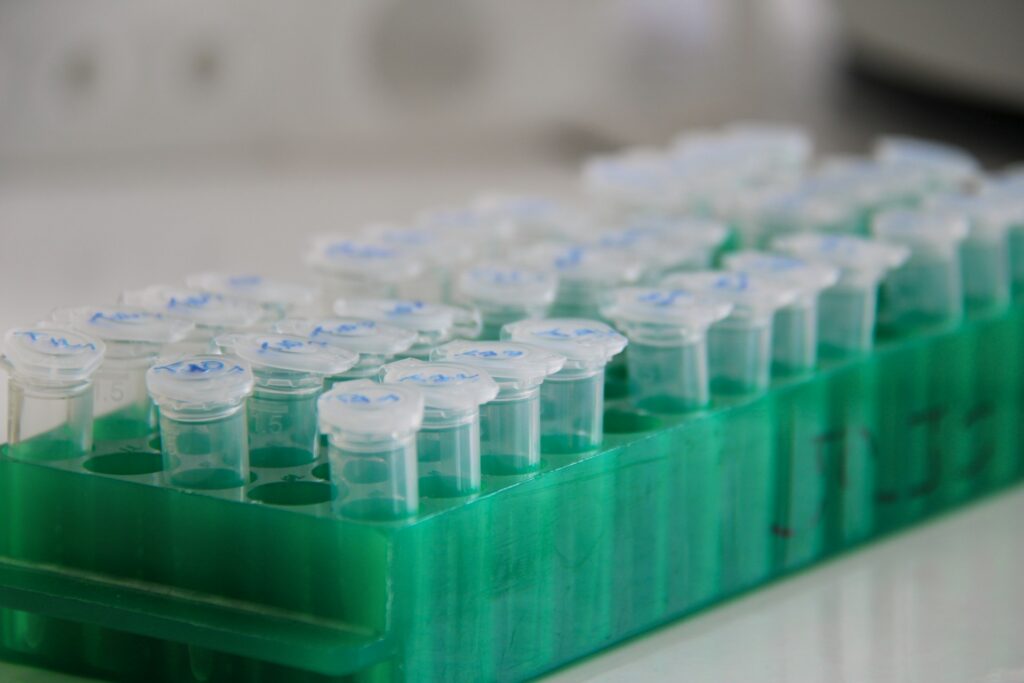 Lab vials in a green tray