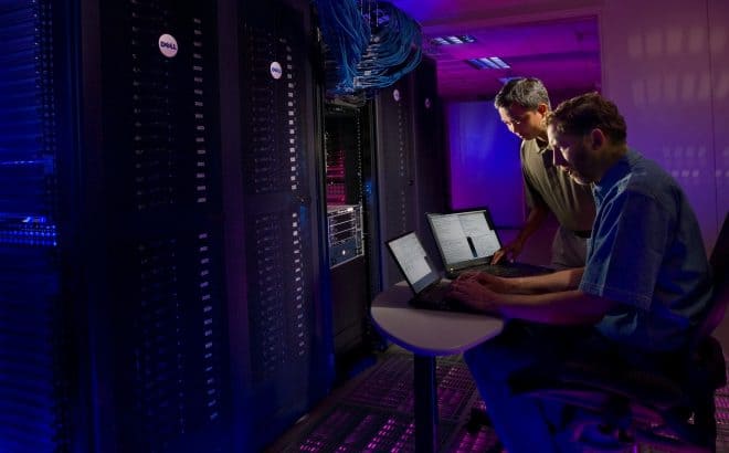 two people working in a data storage center