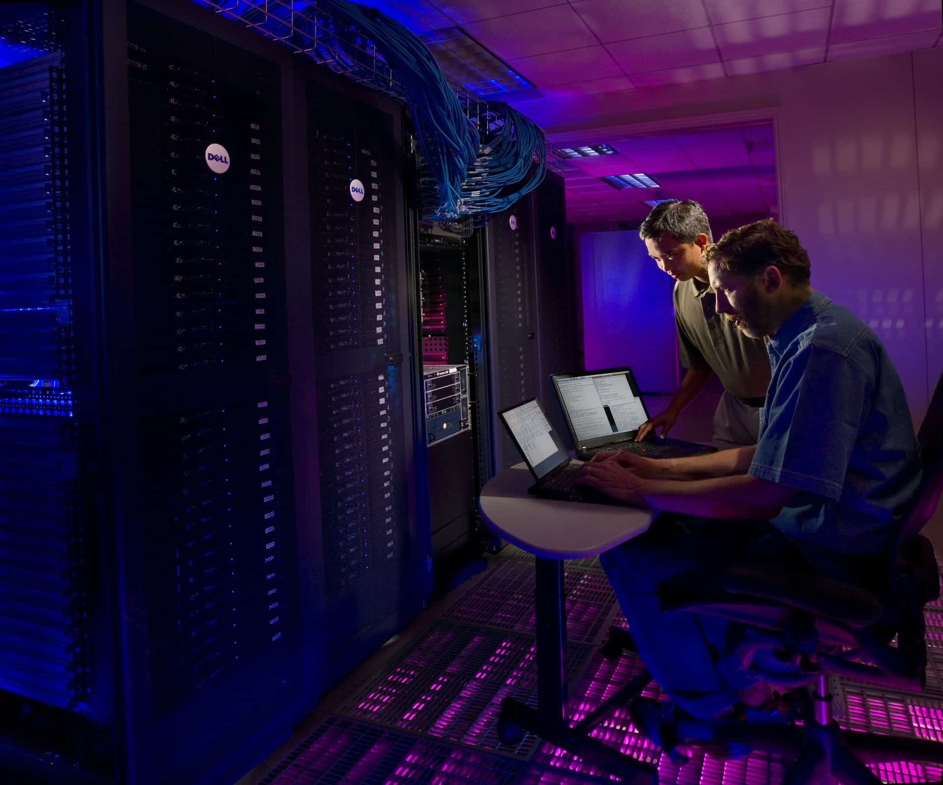 two people working in a data storage center