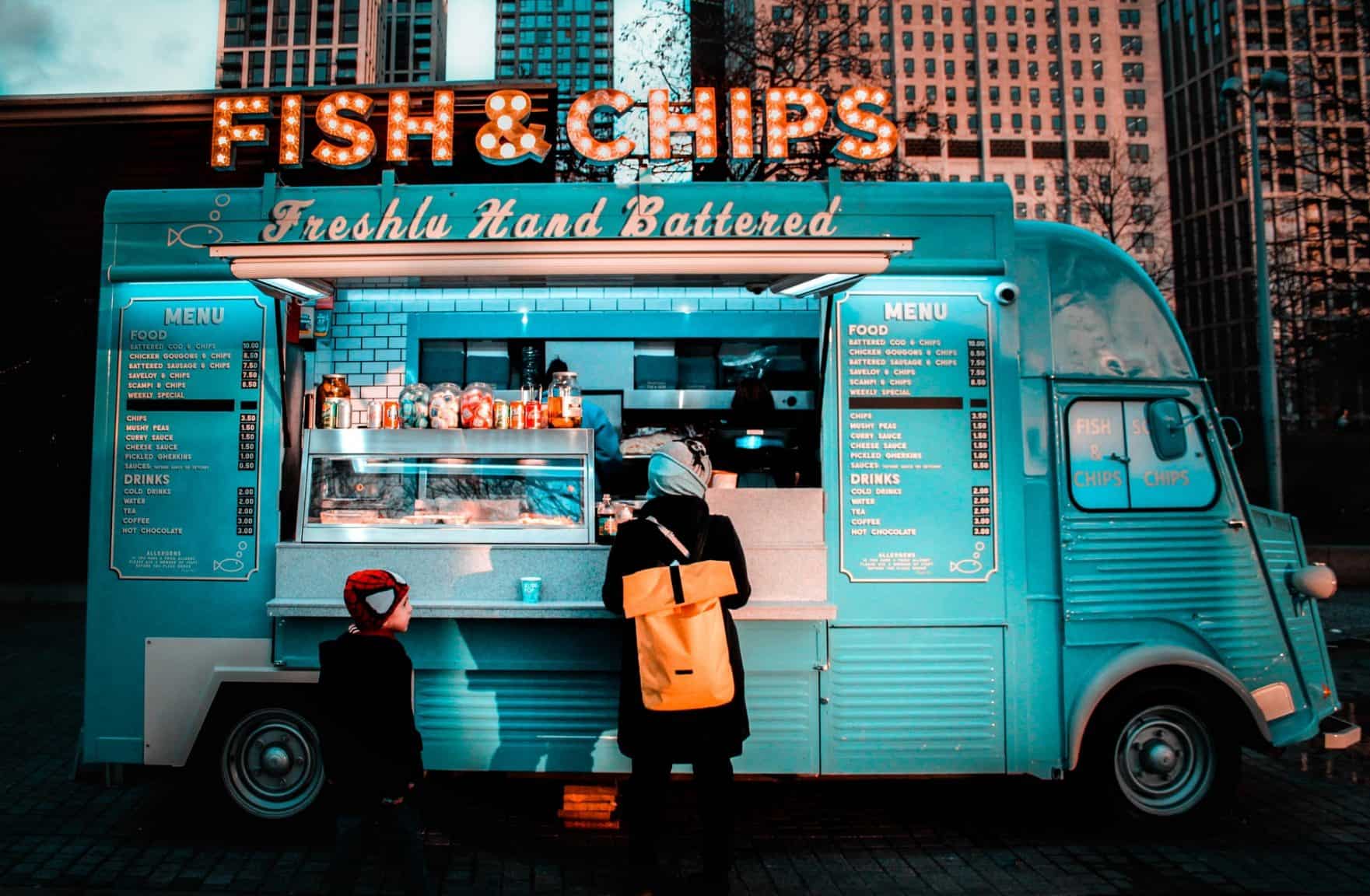 a customer ordering fish and chips using a POS system for food trucks