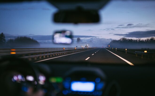 car dashboard on highway at night