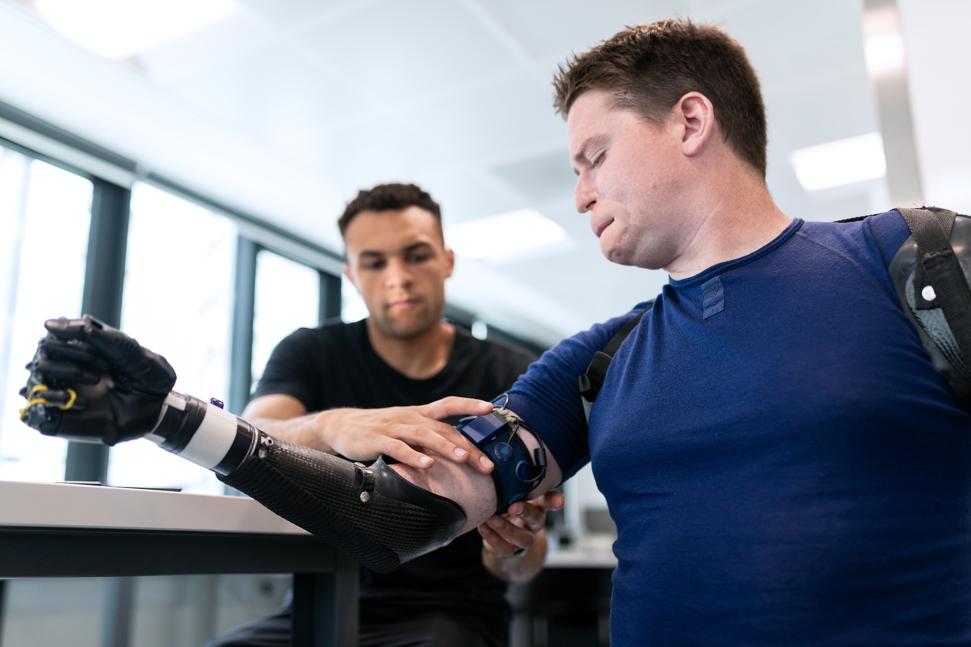 A man wearing a bionic arm developed with biotechnology