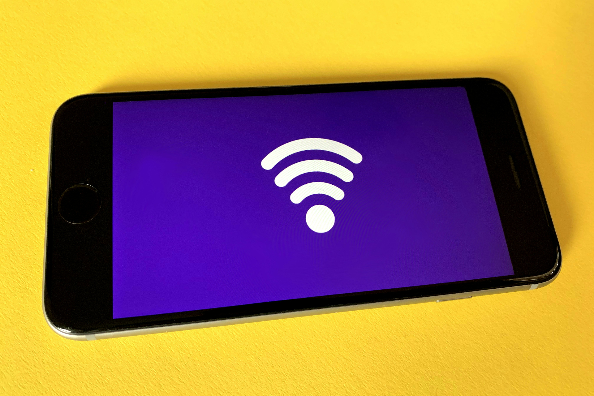 phone with wifi symbol on yellow background