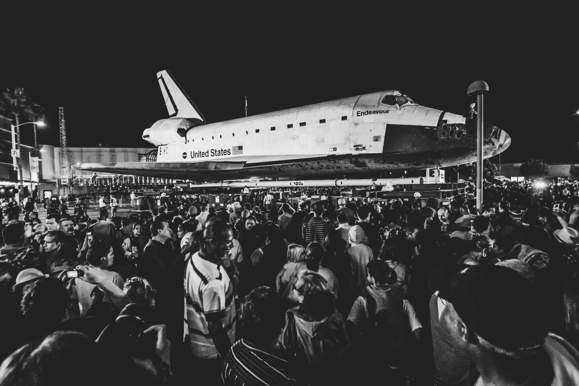 black and white photo of spacecraft in front of crowd