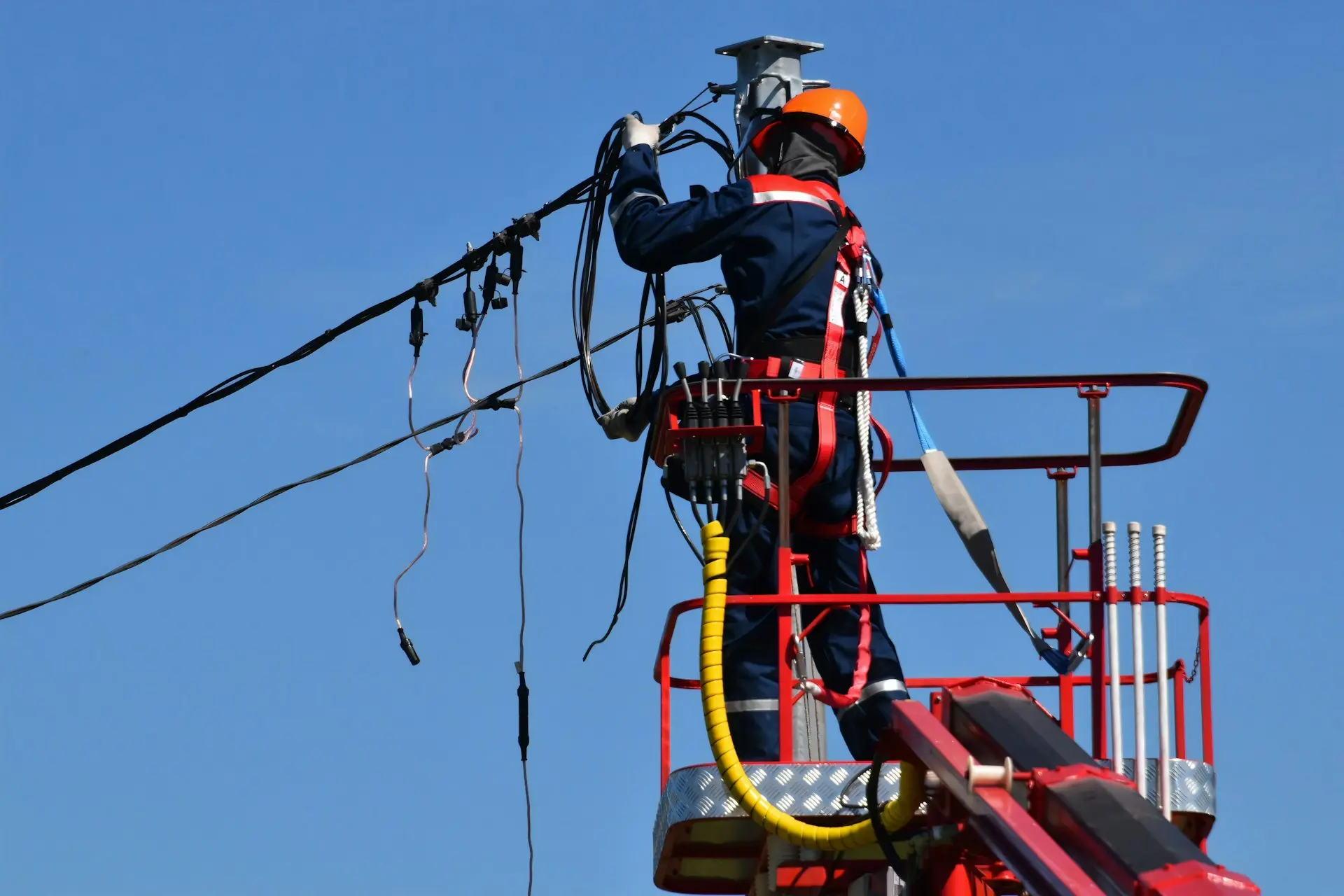 a worker fixing a power line