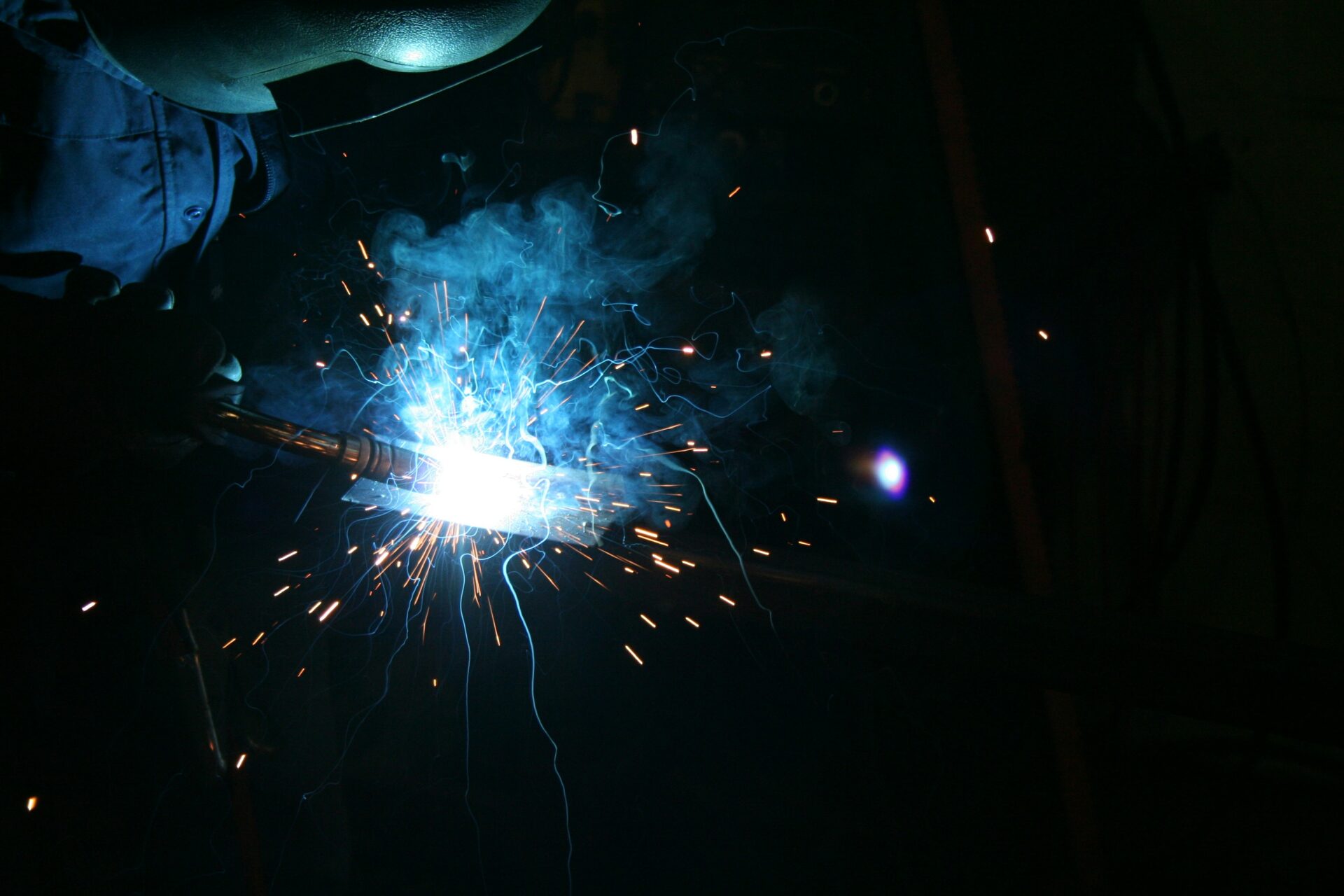 imagine of someone welding, sparks flying