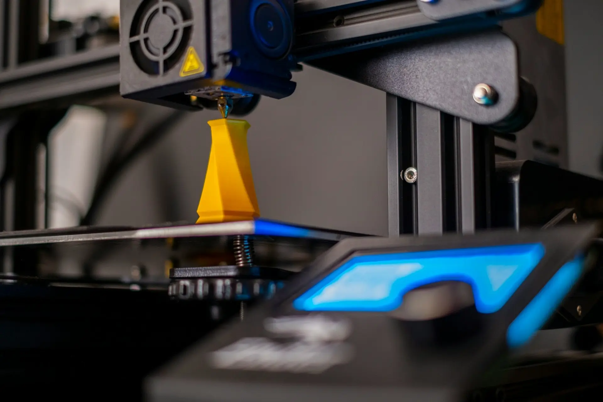 a 3d printer on a desk in a workplace