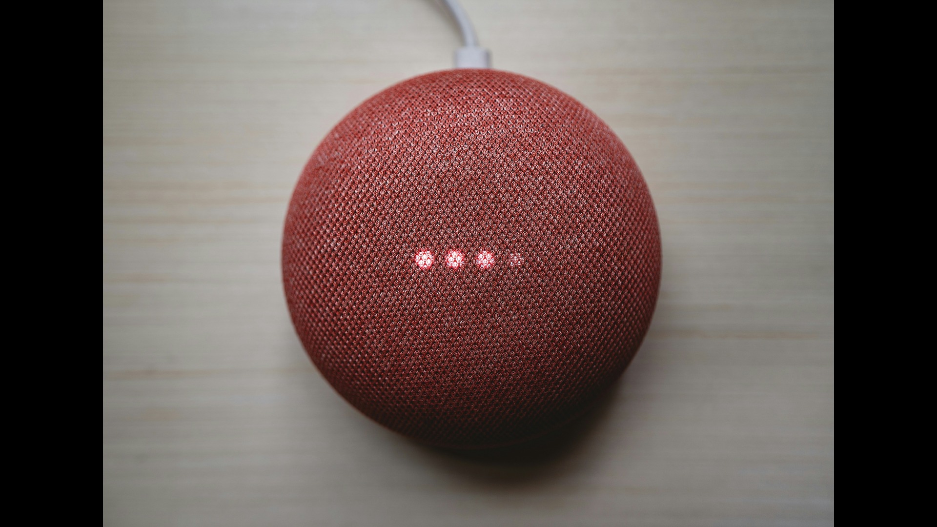 A round red voice assistant device